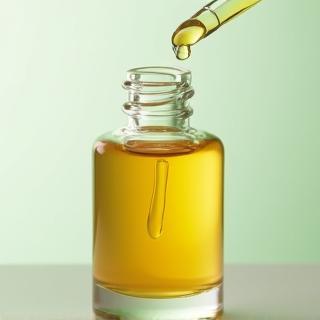 A dropper bottle of face serum with natural ingredients.