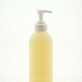 A bottle of natural body lotion with a pump dispenser.