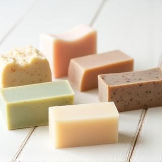 A selection of natural handmade soap bars in different colors and textures.